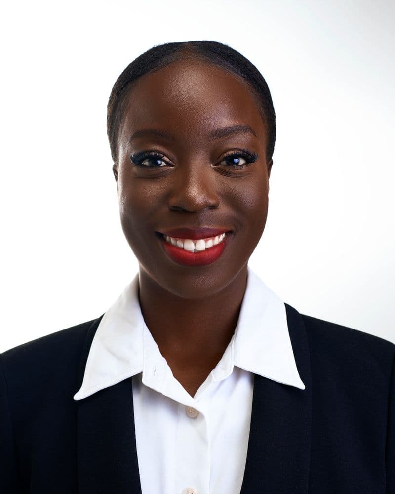 Portrait of a smiling woman in a dark blazer