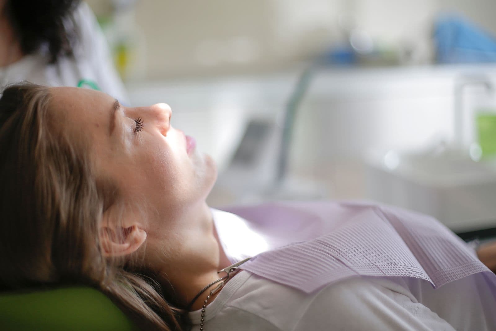 A patient resting calmly on a dental chair in a clean, modern clinic